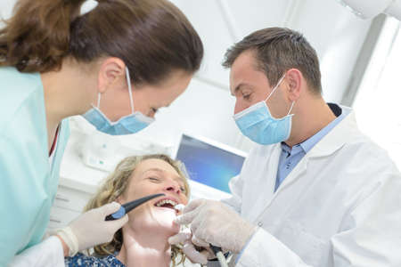 Woman giggling in dentist's chairの写真素材