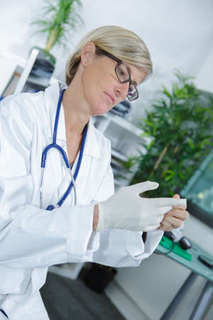 portrait of beautiful female doctor holding injectionの写真素材