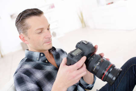 photographer in studio with dslr camera in handの写真素材