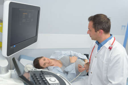 Pregnant lady with gynecologist for ultrasoundの写真素材