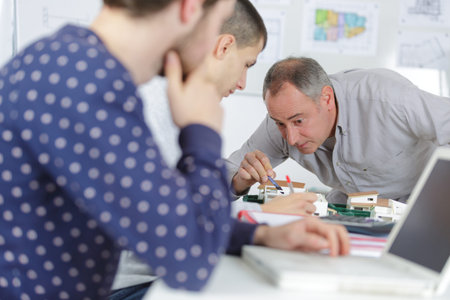 teacher with students in architecture schoolの写真素材
