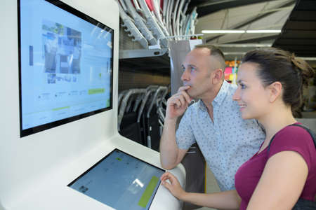 customer looking at the screenの写真素材