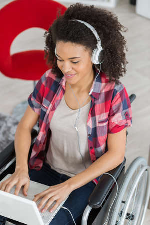 disabled woman listening to music at homeの写真素材