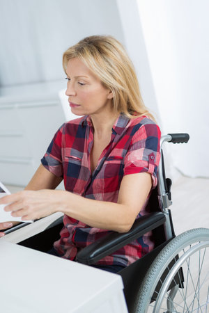 beautiful handicapped woman at homeの写真素材