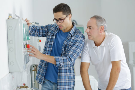workers installing device on the wall