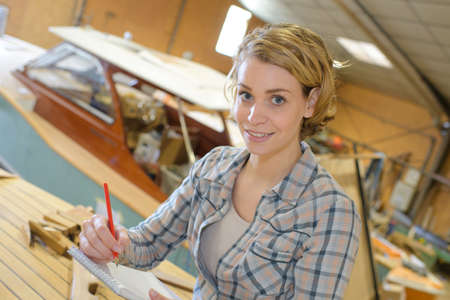 smiling beautiful female marine carpenter at workの写真素材