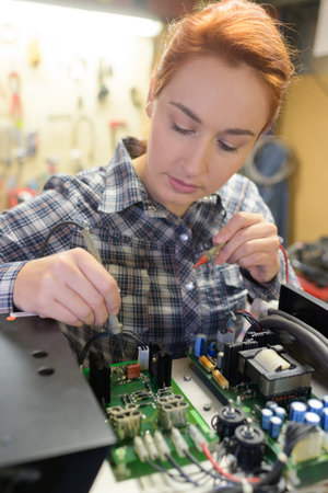 young woman technician repair electronics device