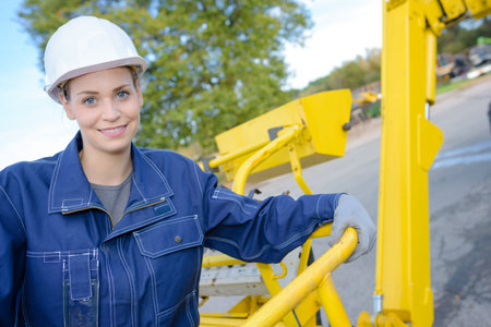 portrait of woman in cherry picker basket