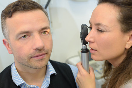 man and eye examination