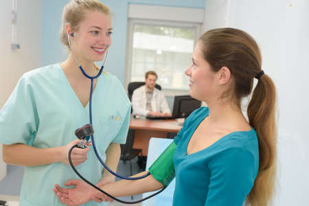 woman doctor takes the strain of a patient womanの写真素材