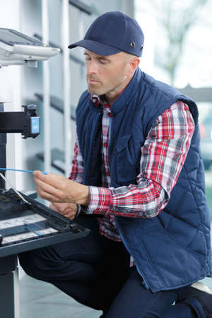 hold a screwdriver for fixing printerの写真素材
