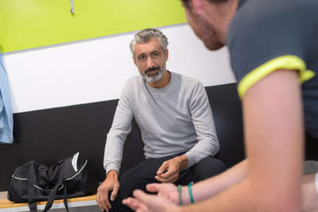 two ment talking in locker roomの写真素材