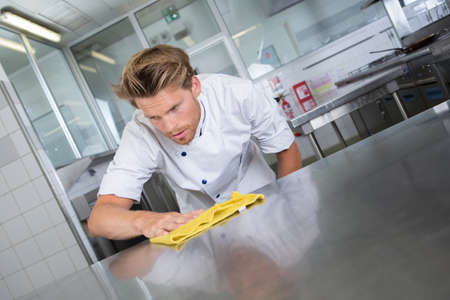 kitchen worker wiping the stationの写真素材