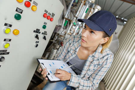 manufacturing worker operating a machineの写真素材