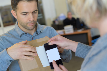 scanning the label on the boxes with barcode scanner