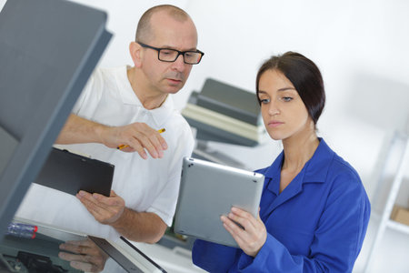 female apprentice using digital tablet