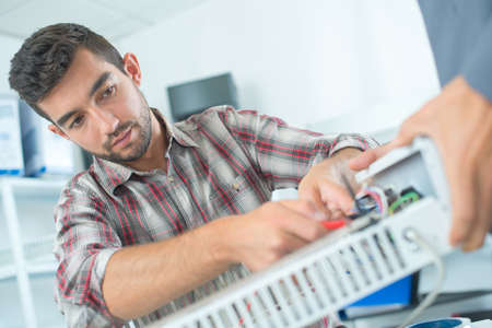 Man working on electrical applianceの写真素材