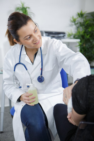 female doctor injecting vaccine