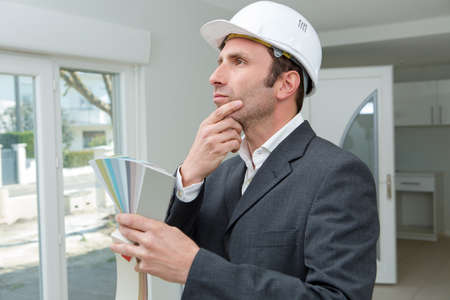 suited man in property holding colour chartsの写真素材