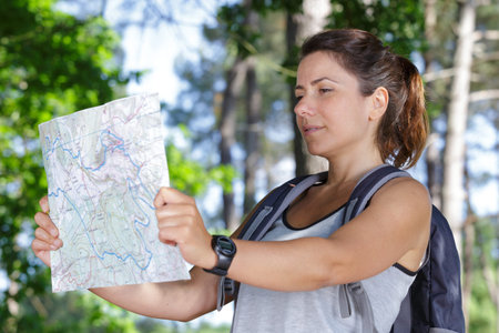 woman with backpack checking the map