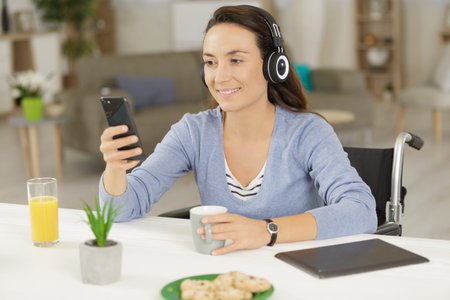 young woman with headset looking at cellphone