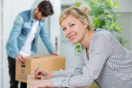 young couple tagging their boxes