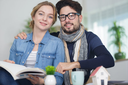 smiling young couple checking a new house