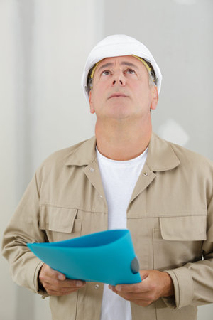 senior inspector looking up in property