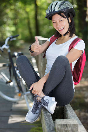 happy cyclist woman showing thumbs upの写真素材