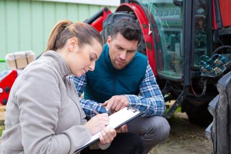 young country woman give to man tractor driver notes
