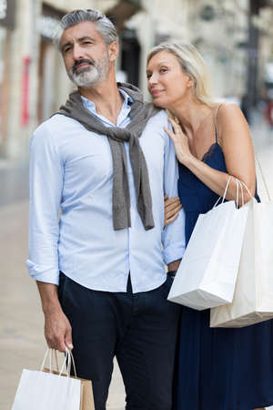 couple standing outside on the city streetの写真素材
