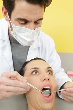 woman in the dentist chair with opened mouthの写真素材