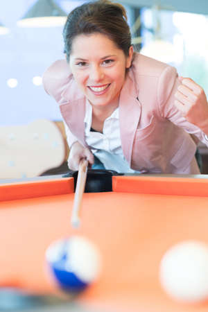 woman aiming for blue pool ballの写真素材
