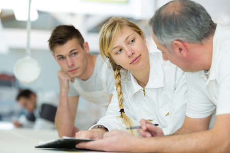 apprentices with paint rollerの写真素材