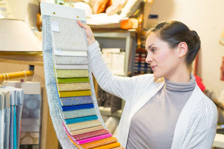 woman chooses samples of colored tissueの写真素材