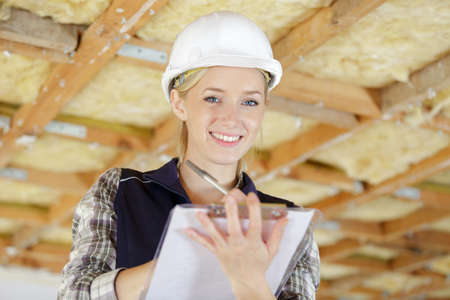 woman construction holding paper clipboardの写真素材