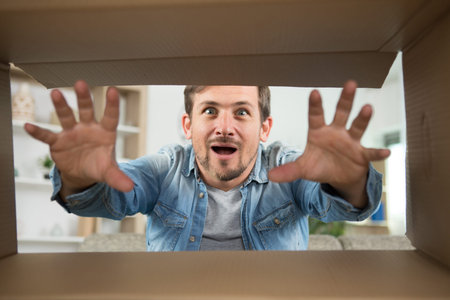 man looking at something inside a box