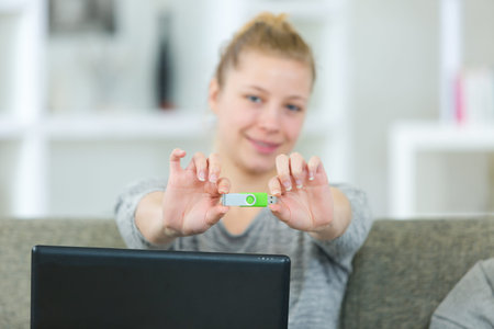 woman before plugging a pendrive on a laptop