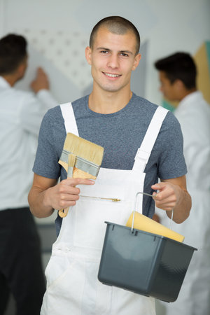 portrait of a young house painter and decorator apprentice