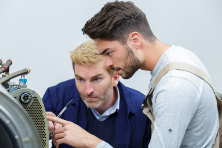 teacher and student in auto mechanics training class