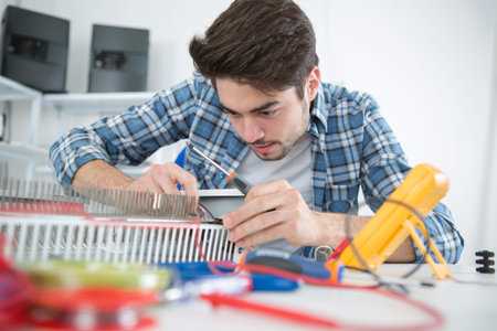 young electrical appliance assembler at work