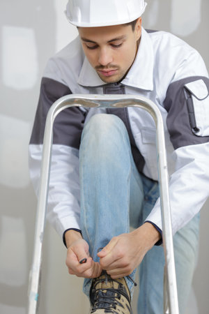 young builder on a ladderの写真素材