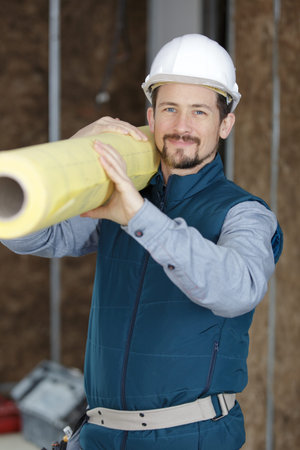 professional construction engineer holding paper roll