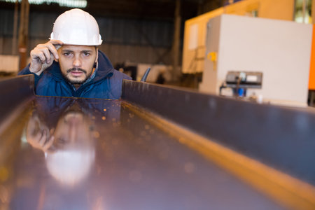 builder in hard hat looking at an industrial interior