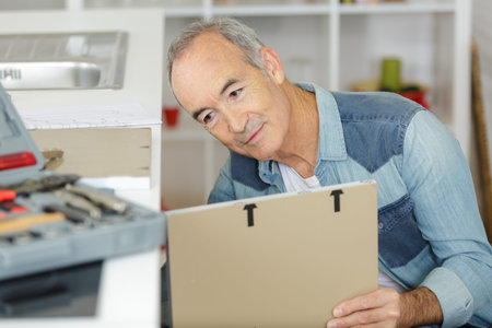 senior man fixing a furniture