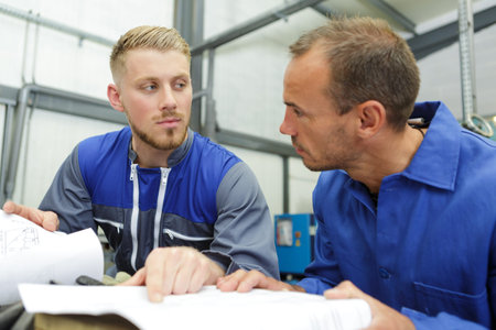 two mechanics talking about paperwork