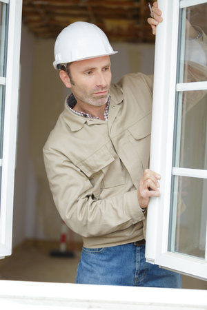 worker is installing a corner window