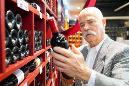 client reading a wine labelの写真素材