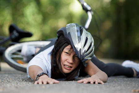 active woman fell off her bicycleの写真素材