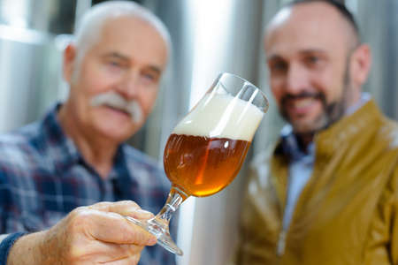 close up of men working at breweryの写真素材